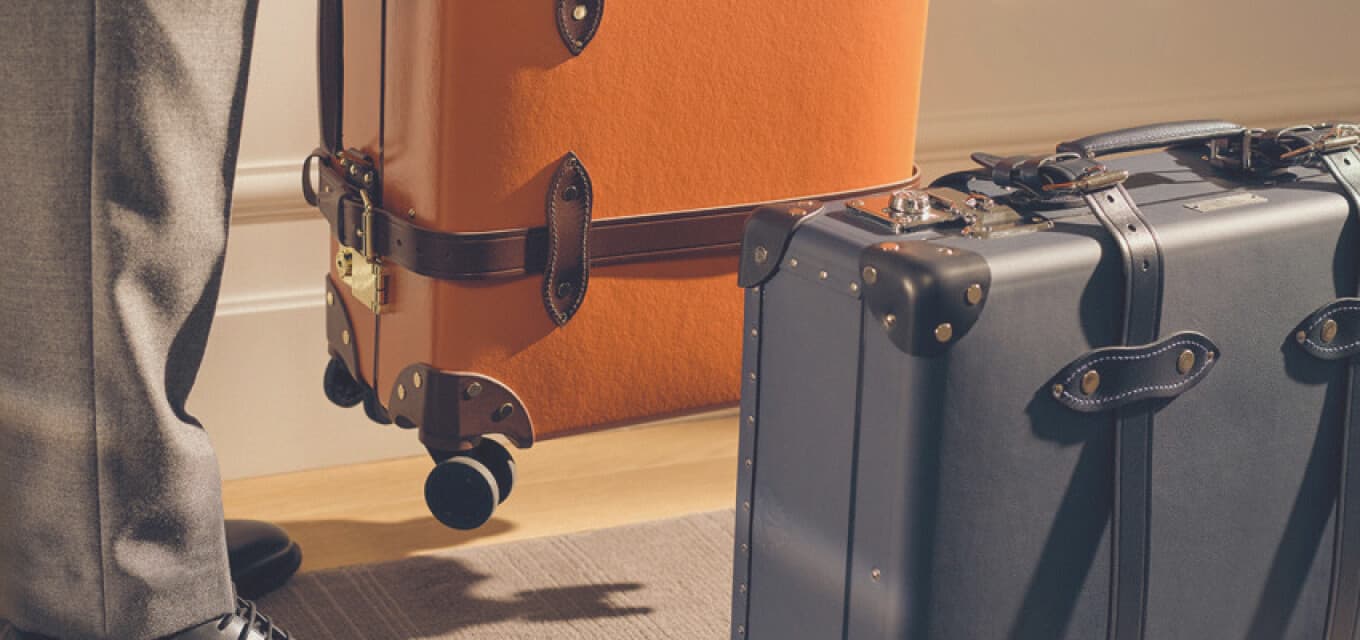 Man with suitcases at Corinthia Hotels